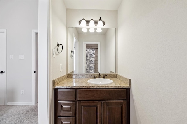 bathroom with a shower with shower curtain and vanity