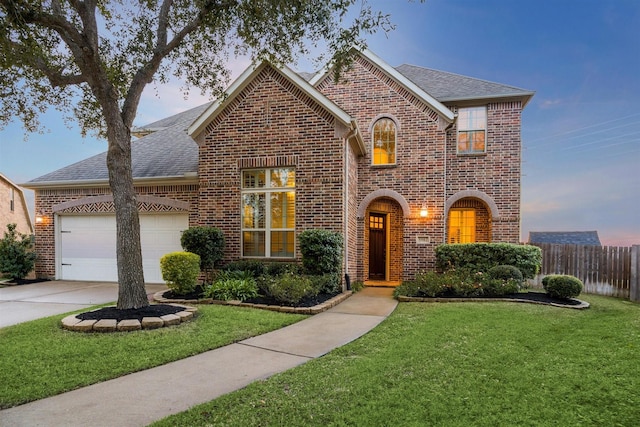 view of front of house featuring a garage and a yard