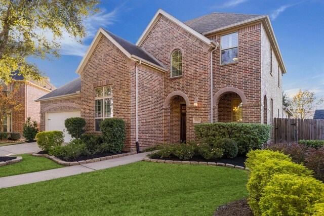 view of front of house with a garage and a front yard