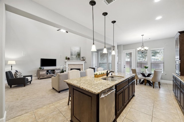 kitchen featuring dark brown cabinetry, dishwasher, sink, light colored carpet, and a kitchen island with sink