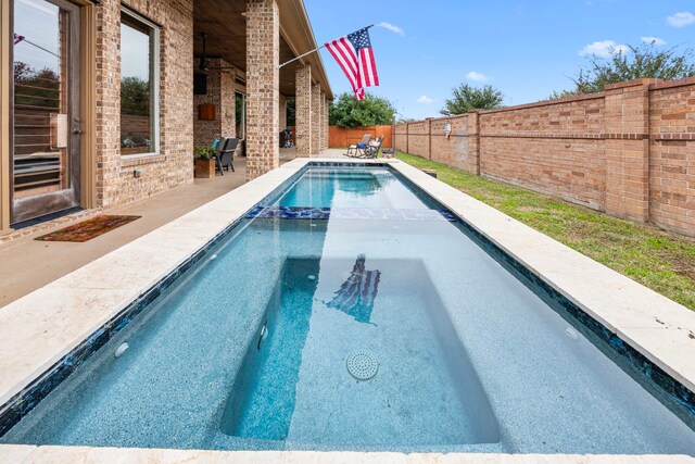 view of swimming pool with a patio area