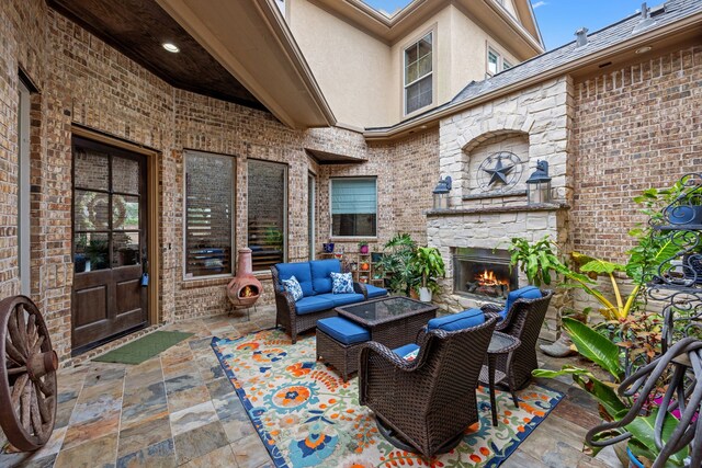 view of patio / terrace featuring an outdoor living space with a fireplace