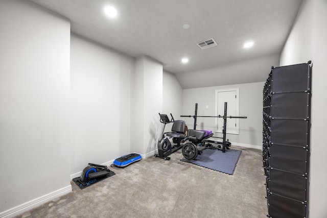 exercise room featuring carpet flooring and vaulted ceiling