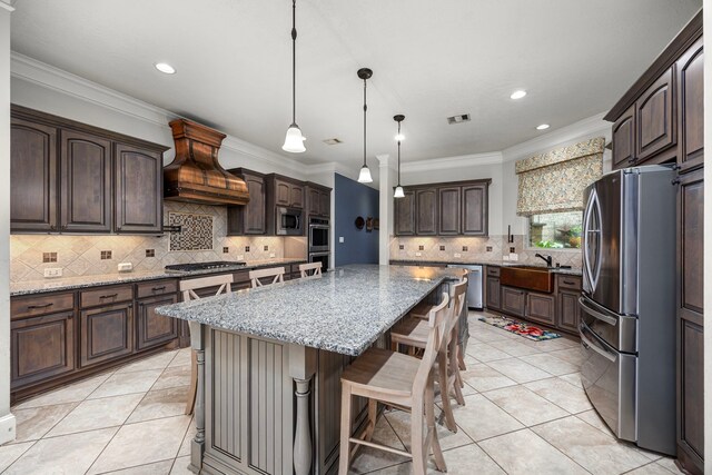 kitchen with stainless steel appliances, dark brown cabinets, a center island, and custom range hood