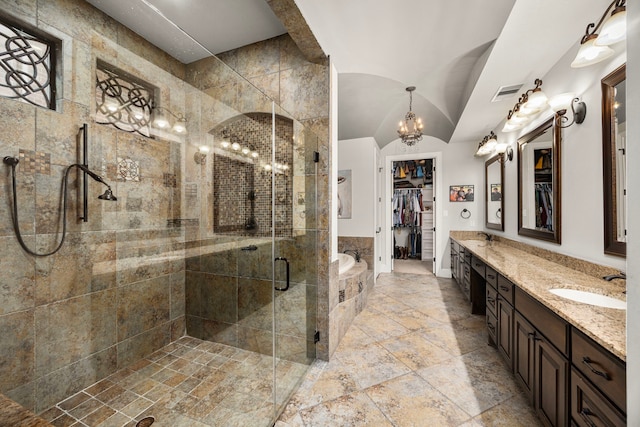 bathroom featuring lofted ceiling, vanity, shower with separate bathtub, and a chandelier