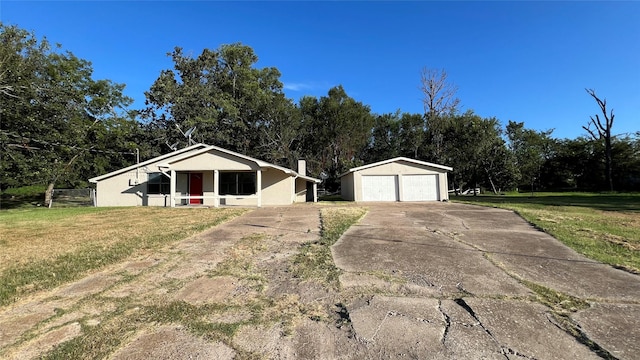 single story home with an outbuilding, a front lawn, and a garage