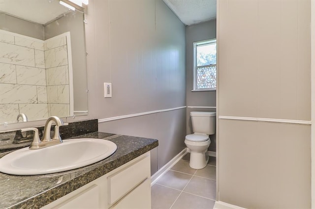 bathroom featuring tile patterned floors, vanity, and toilet