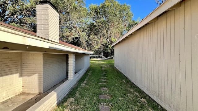 view of side of home with a lawn