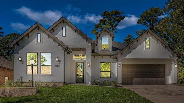 view of front of home featuring a front lawn and a garage