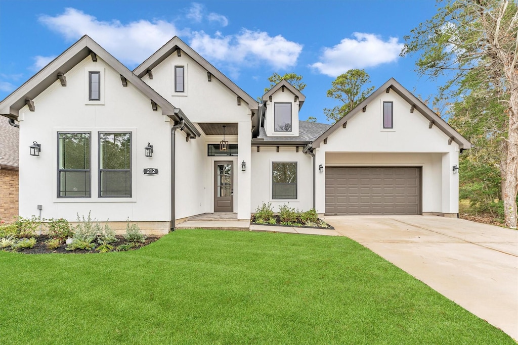 view of front of house featuring a garage and a front lawn