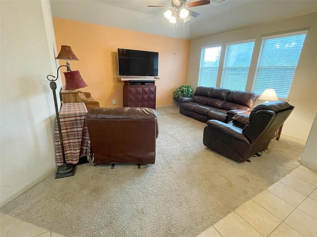 carpeted living room with ceiling fan