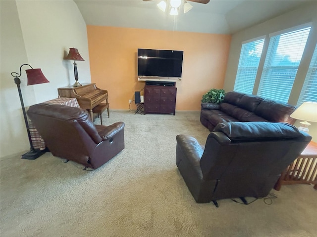 carpeted living room with ceiling fan and lofted ceiling