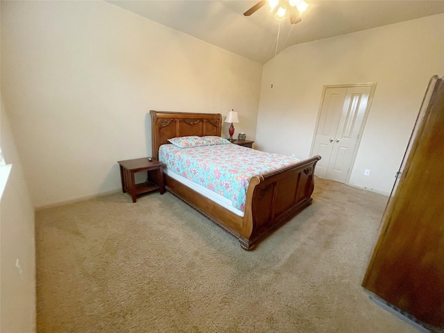 bedroom with a closet, light colored carpet, ceiling fan, and lofted ceiling