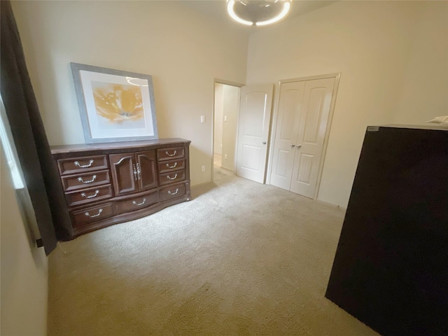 bedroom featuring a closet and light colored carpet