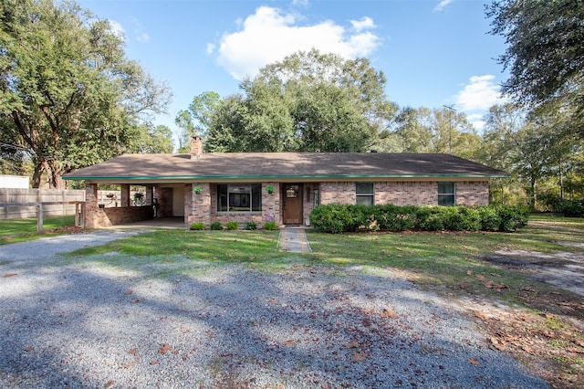 ranch-style home featuring a front yard and a carport