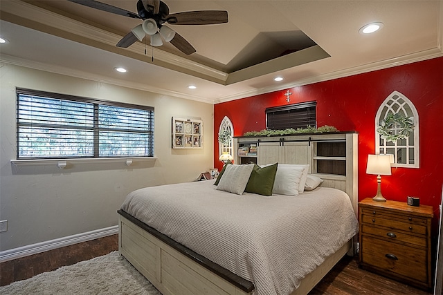 bedroom with wood-type flooring, a raised ceiling, ceiling fan, and ornamental molding