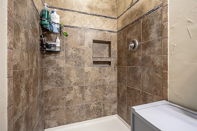 bathroom with a tile shower