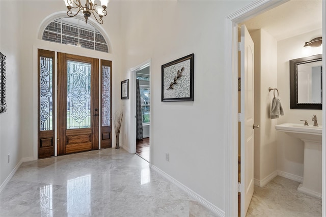 foyer featuring plenty of natural light and an inviting chandelier