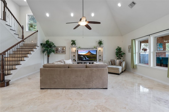 living room with ceiling fan and high vaulted ceiling