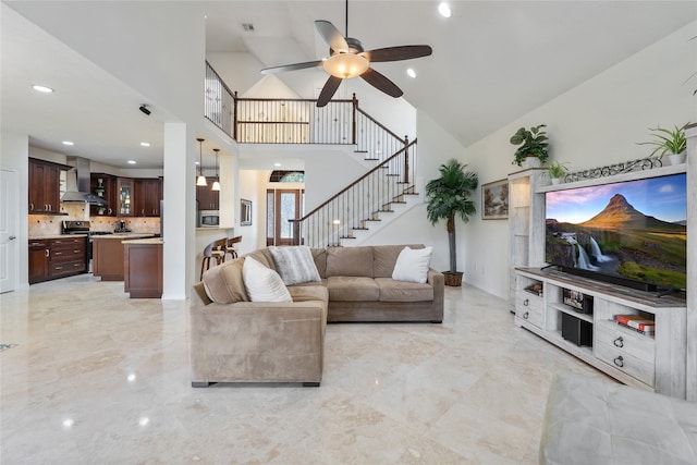 living room featuring ceiling fan and lofted ceiling