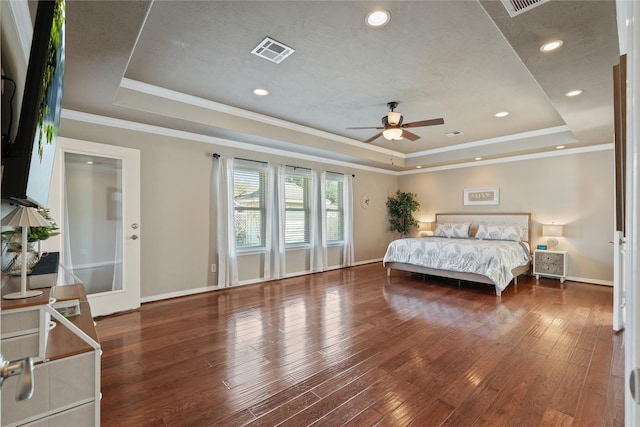 bedroom featuring wood-type flooring, a raised ceiling, ceiling fan, and ornamental molding