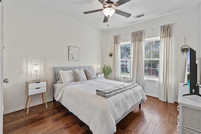 bedroom with ceiling fan and dark hardwood / wood-style floors