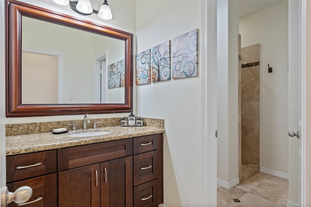 bathroom featuring a shower and vanity