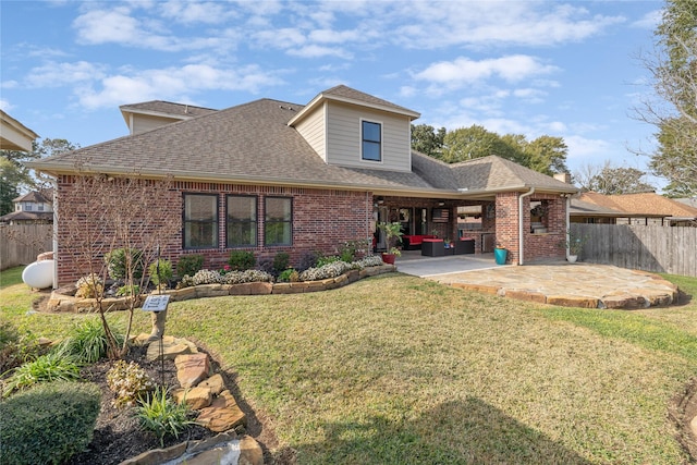 rear view of house with a yard and a patio