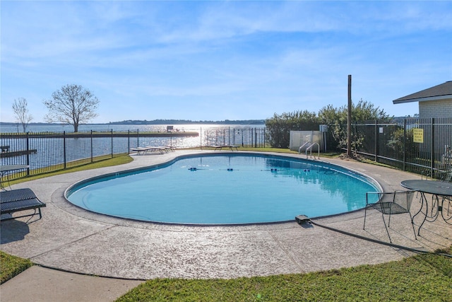 view of pool featuring a patio and a water view