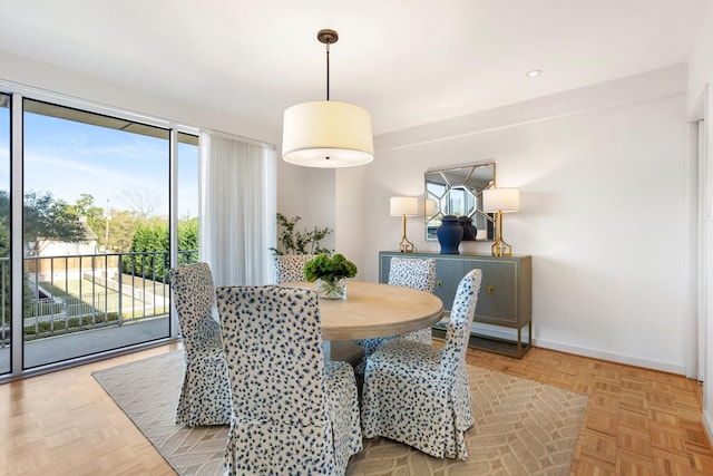 dining area featuring light parquet floors