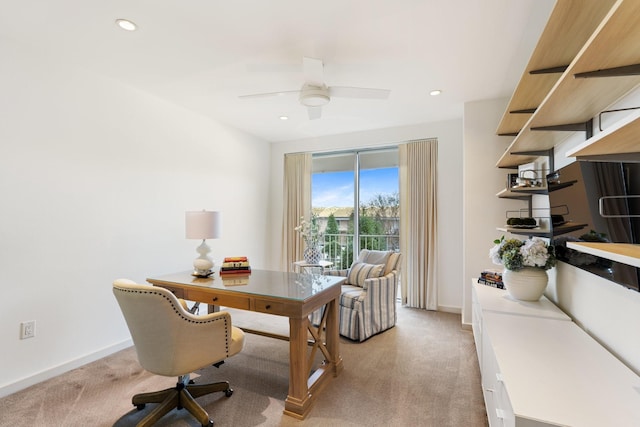 carpeted home office featuring ceiling fan