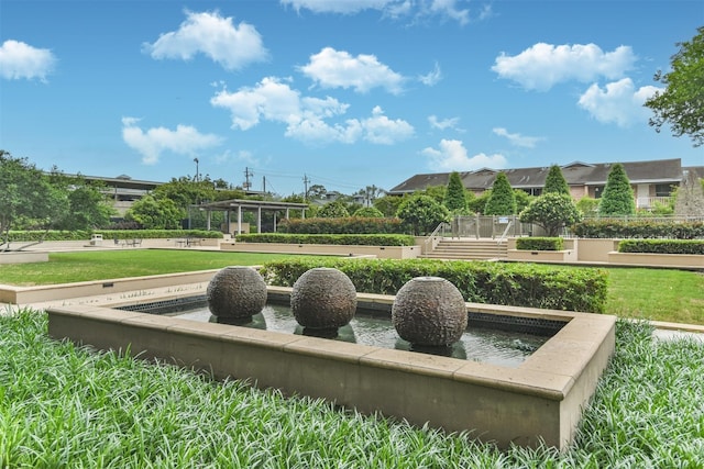 surrounding community featuring a yard and a water view