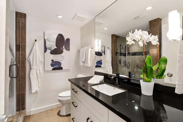 bathroom featuring toilet, tile patterned floors, walk in shower, and vanity