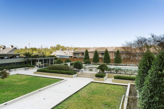 view of property's community with a yard