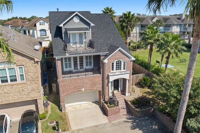 view of front of home featuring a balcony and a garage