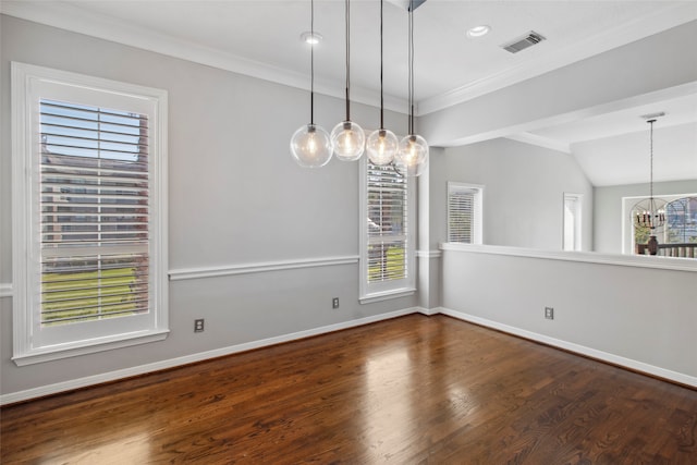 empty room featuring hardwood / wood-style floors, a notable chandelier, crown molding, and vaulted ceiling