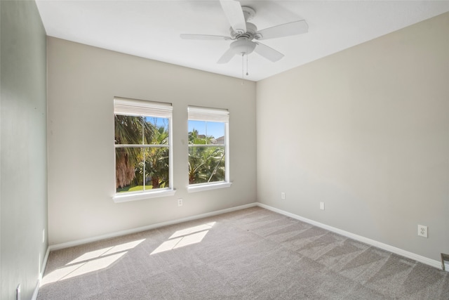 unfurnished room with ceiling fan and light colored carpet