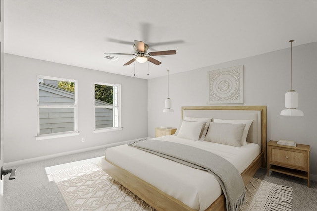 carpeted bedroom featuring visible vents, ceiling fan, and baseboards