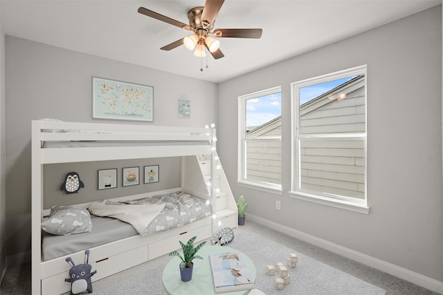 bedroom with a ceiling fan, carpet, and baseboards