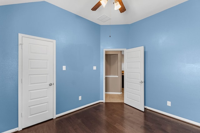 unfurnished bedroom with ceiling fan, dark hardwood / wood-style floors, and vaulted ceiling