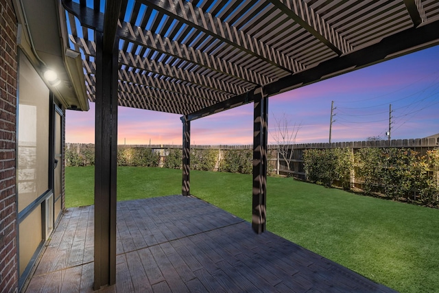 patio terrace at dusk with a pergola and a lawn