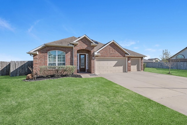 view of front of home with a front lawn and a garage