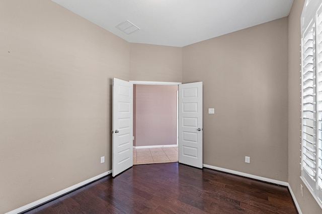 unfurnished bedroom with dark hardwood / wood-style floors