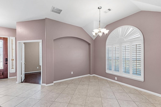 interior space featuring a chandelier, vaulted ceiling, and plenty of natural light