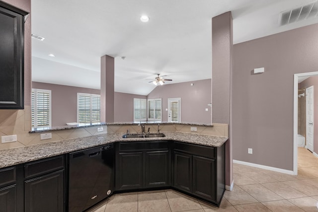 kitchen with ceiling fan, sink, black dishwasher, light stone counters, and lofted ceiling