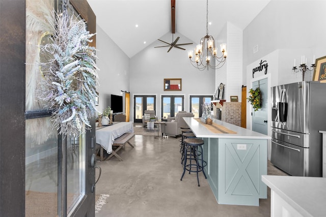 kitchen featuring a center island, high vaulted ceiling, ceiling fan with notable chandelier, beamed ceiling, and stainless steel fridge with ice dispenser