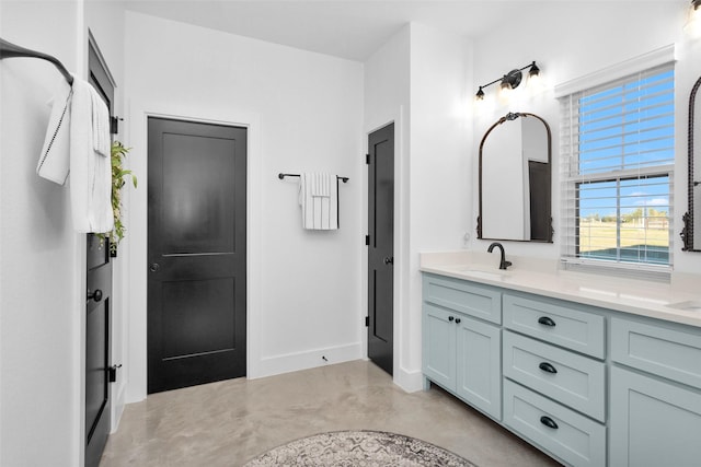 bathroom with vanity and concrete flooring