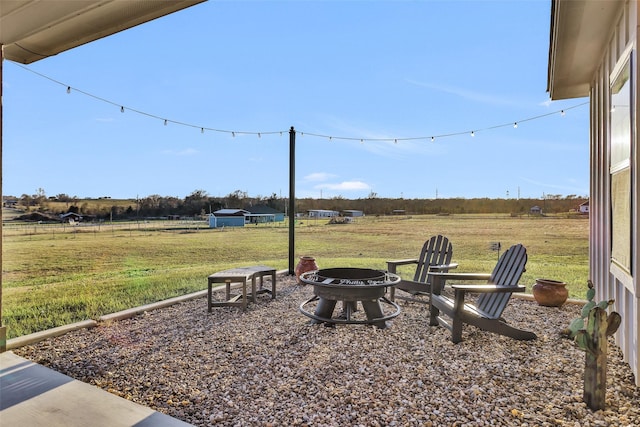 view of yard featuring a rural view and a fire pit