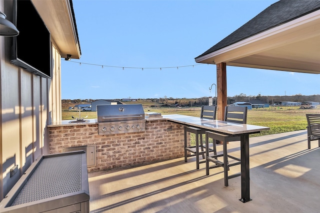 view of patio featuring area for grilling and exterior kitchen