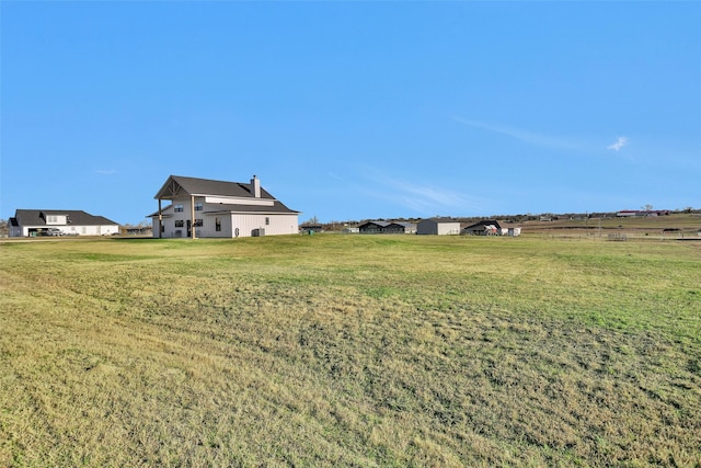 view of yard with a rural view